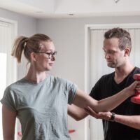 physiotherapist in Copenhagen training with a lady in pain
